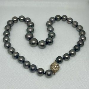 A strand of Tahitian Black / rainbow pearls with 18 karat diamond clasp